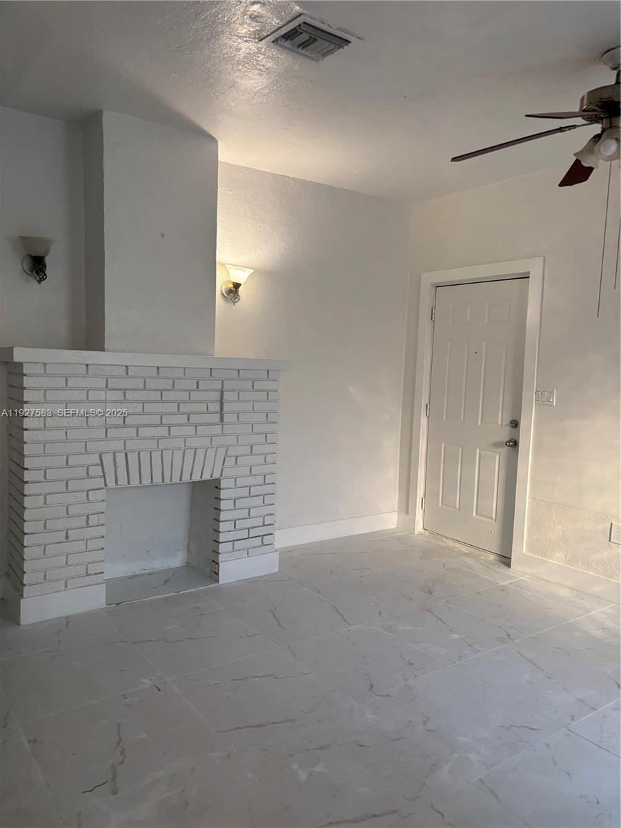 568 Southwest 3rd Street, Unit LEFT 566 Miami, FL 33130 - Photo 1 of 17 a view of empty room with a fireplace