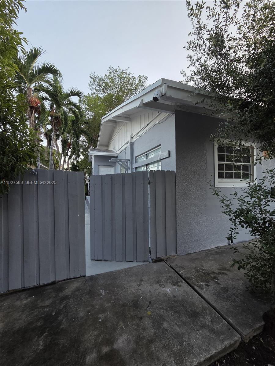 568 Southwest 3rd Street, Unit LEFT 566 Miami, FL 33130 - Photo 11 of 17 a backyard of a house with plants and trees