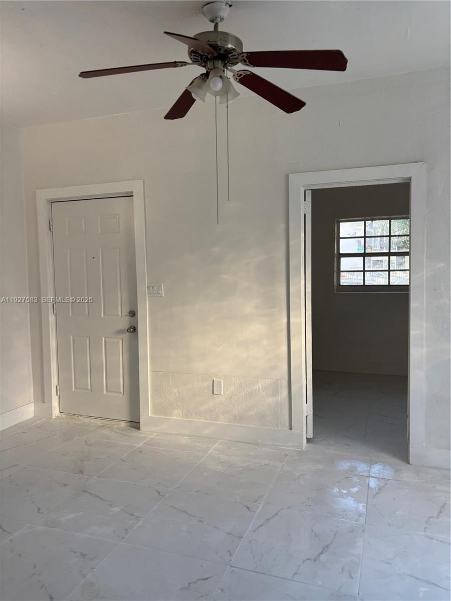 568 Southwest 3rd Street, Unit LEFT 566 Miami, FL 33130 - Photo 2 of 17 a view of an empty room with a fan and a window