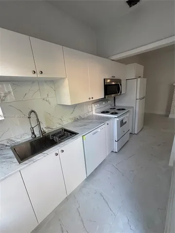 a kitchen with stainless steel appliances granite countertop a sink and a stove