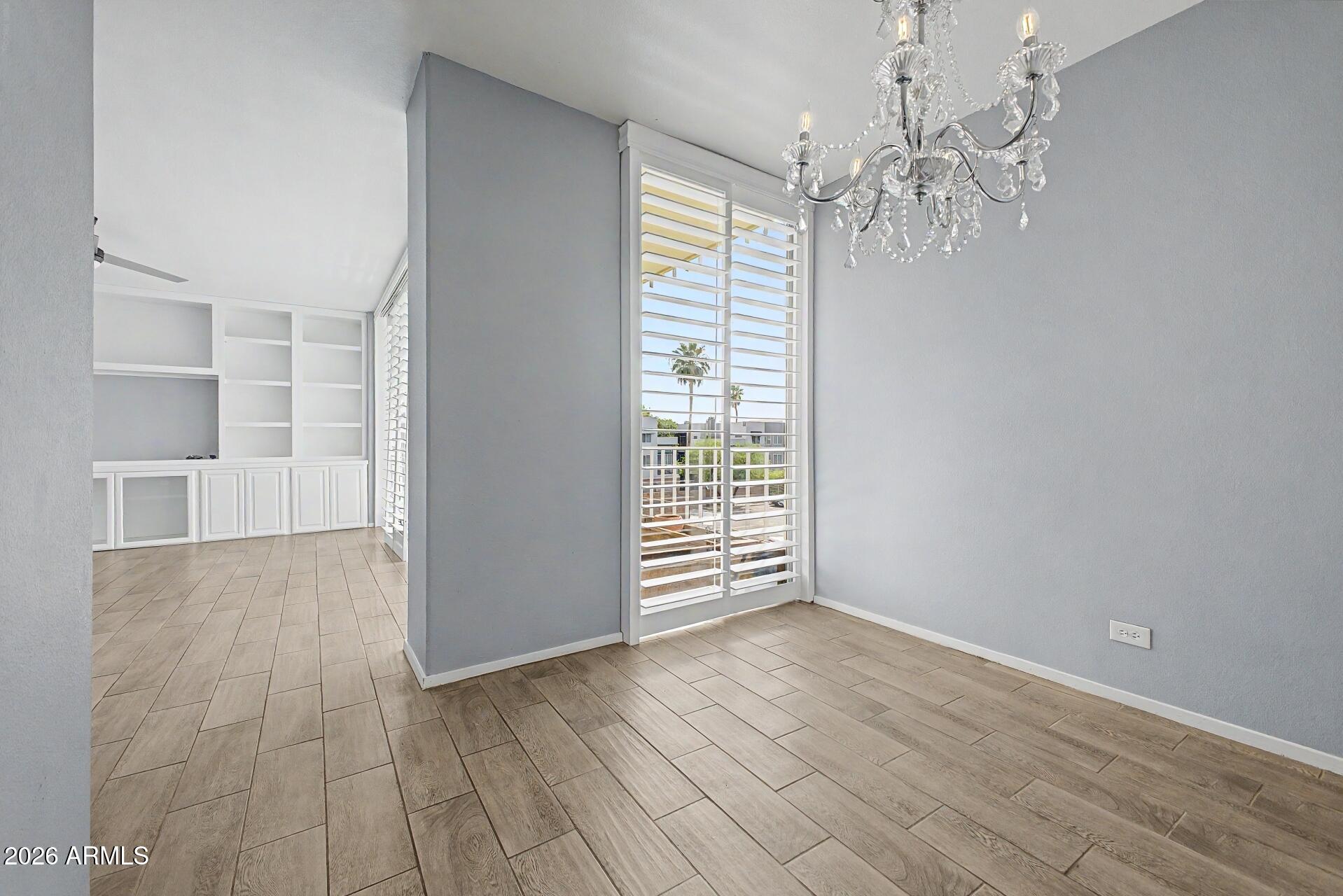207 West Clarendon Avenue, Unit B2 Phoenix, AZ 85013 - Photo 4 of 30 wooden floor in an empty room with a window