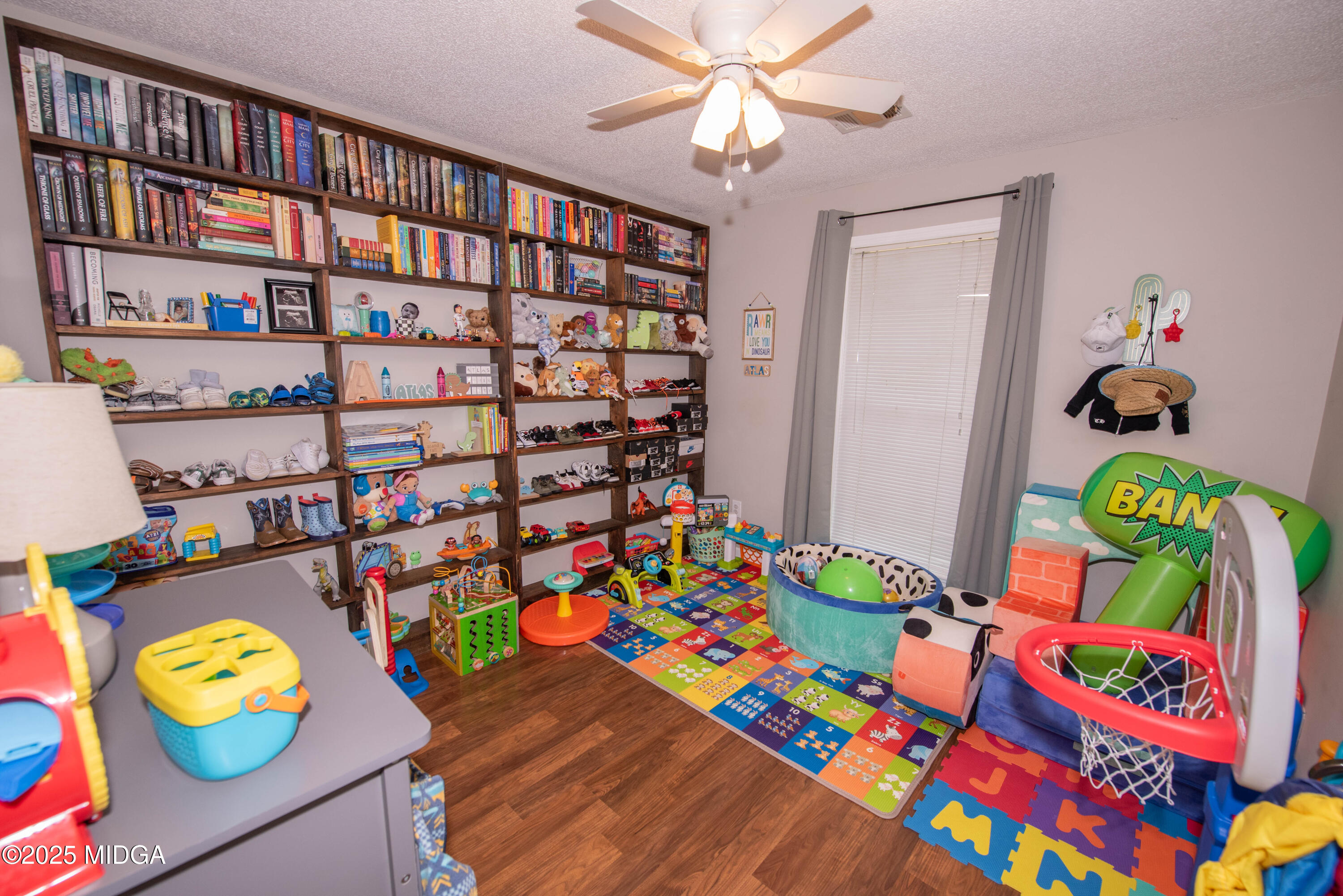 111 Oak Ridge Drive Warner Robins, GA 31093 - Photo 15 of 25 a play room with toys and a book shelf