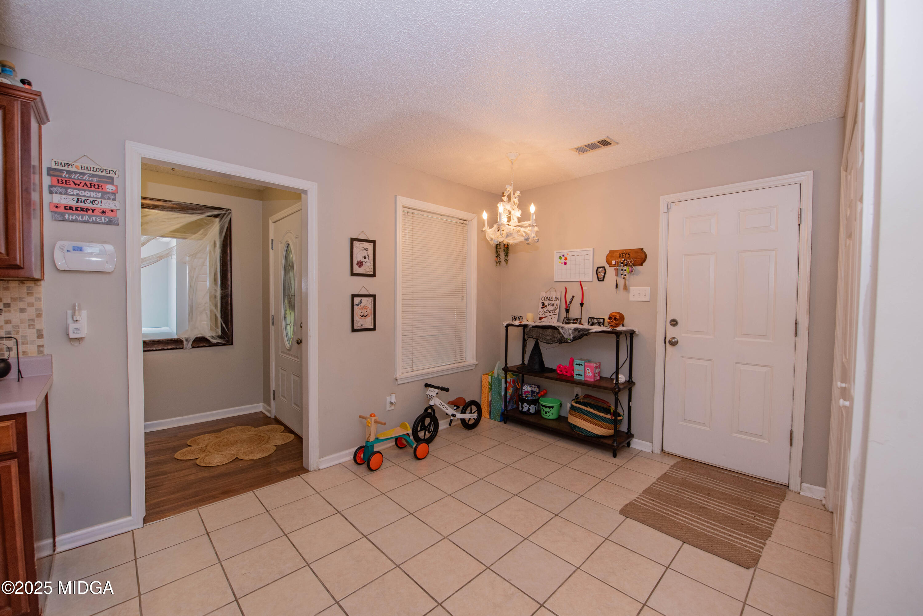 111 Oak Ridge Drive Warner Robins, GA 31093 - Photo 6 of 25 a living room with furniture and a flat screen tv