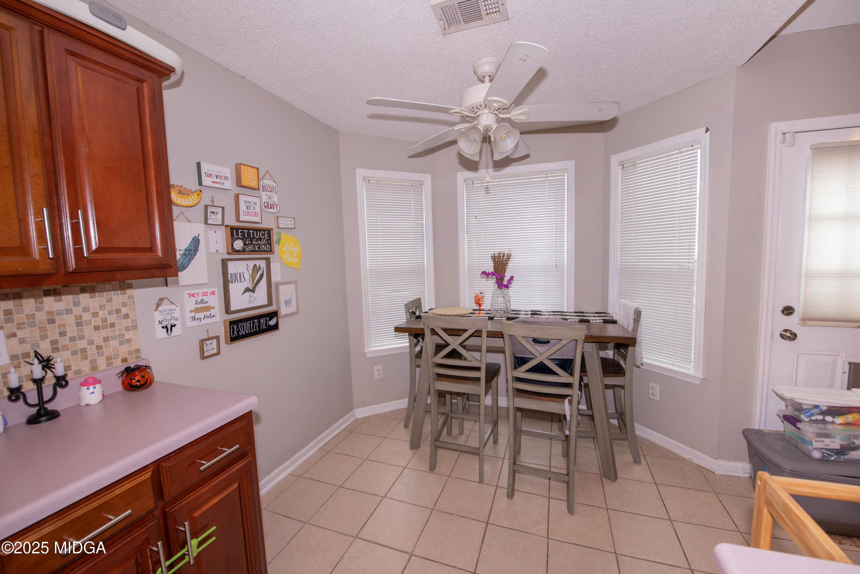 111 Oak Ridge Drive Warner Robins, GA 31093 - Photo 9 of 25 a view of a dining room with furniture and chandelier