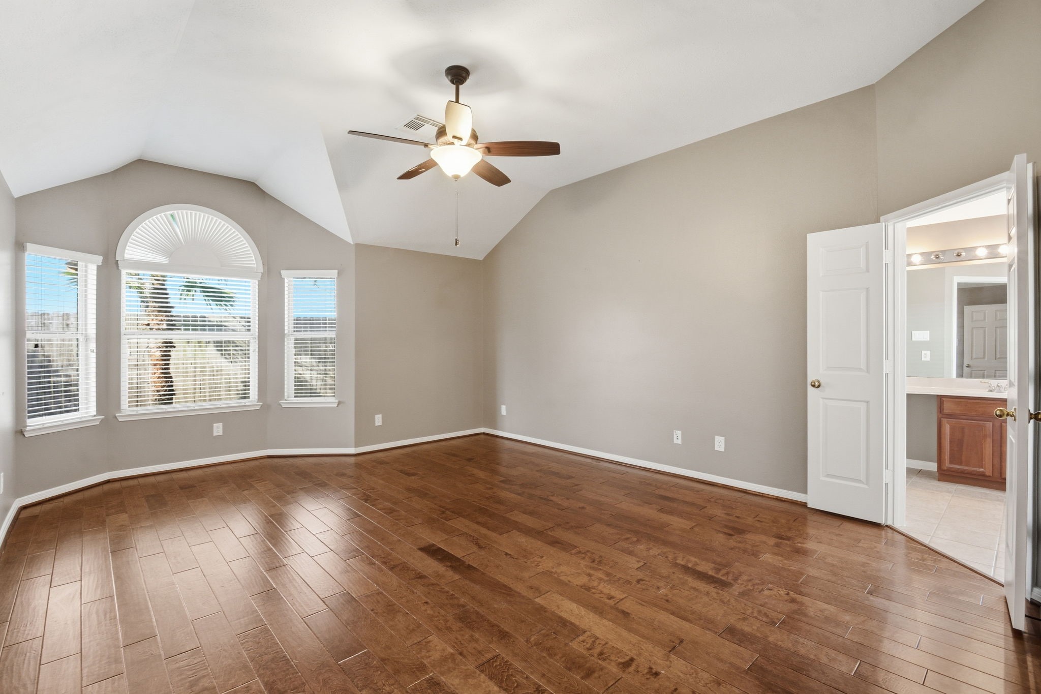 18915 Rustling Ridge Drive Tomball, TX 77377 - Photo 16 of 27 an empty room with wooden floor fan and windows