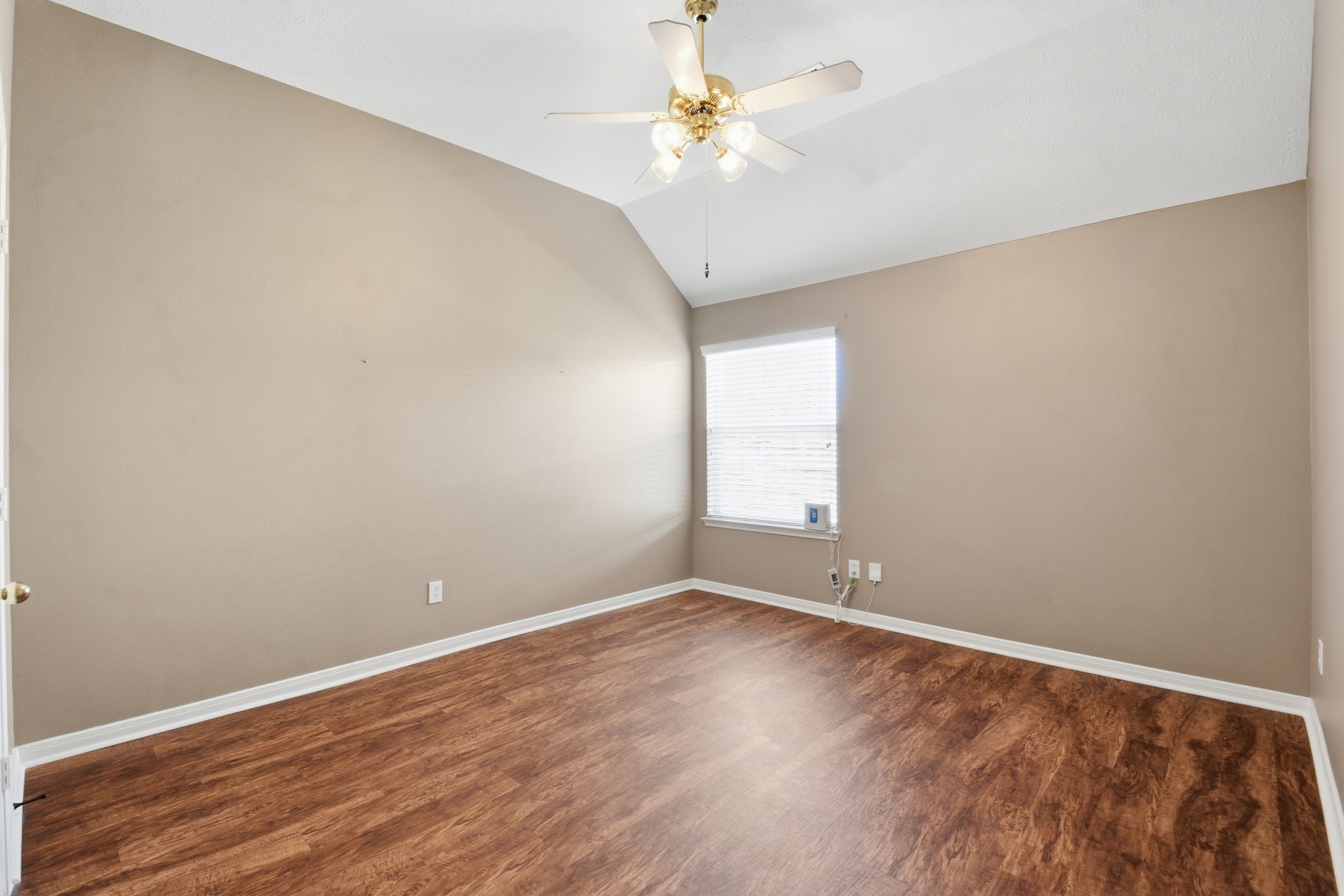 18915 Rustling Ridge Drive Tomball, TX 77377 - Photo 20 of 27 a view of an empty room with window and wooden floor