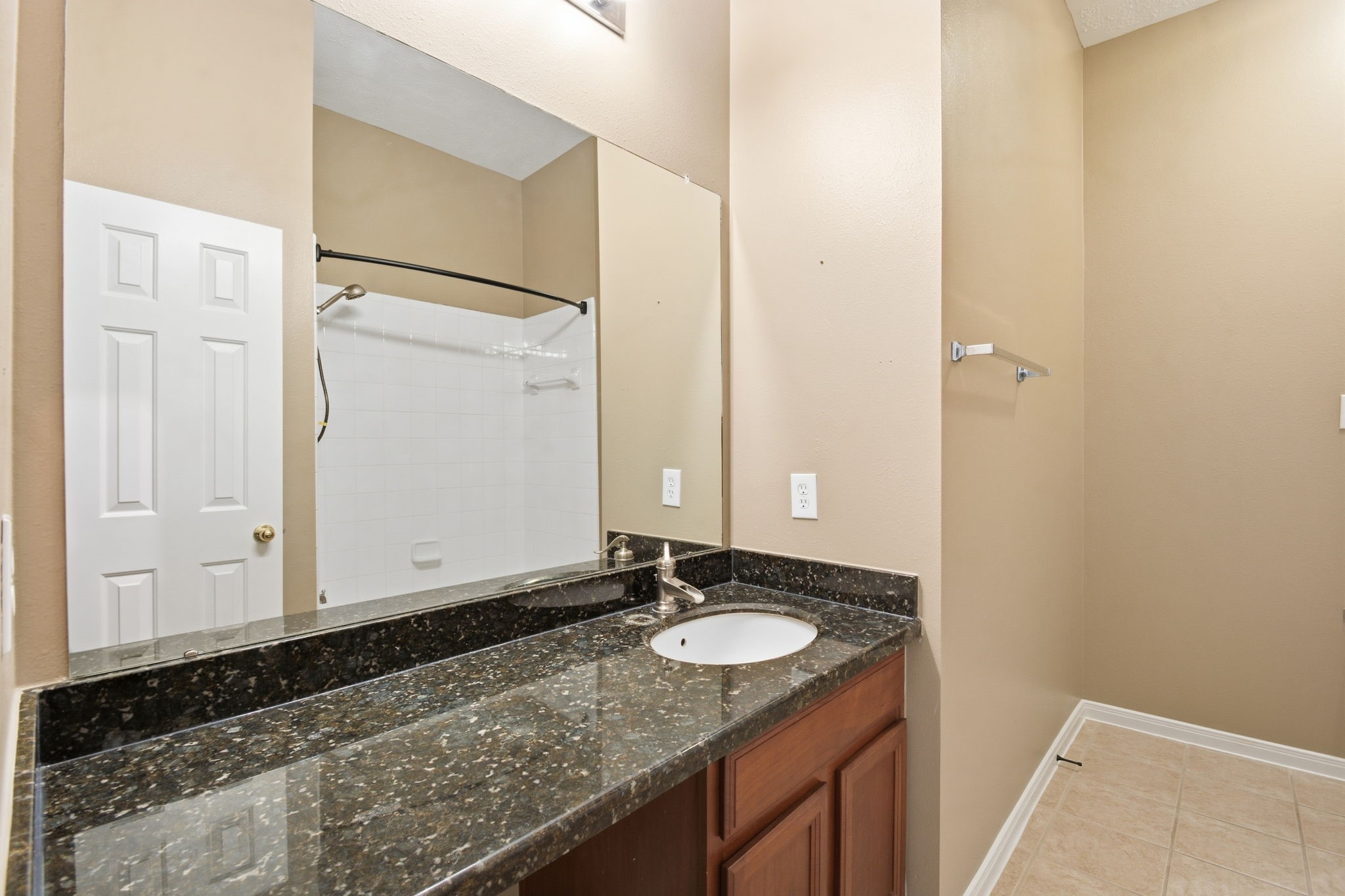 18915 Rustling Ridge Drive Tomball, TX 77377 - Photo 22 of 27 a bathroom with a granite countertop sink and a mirror