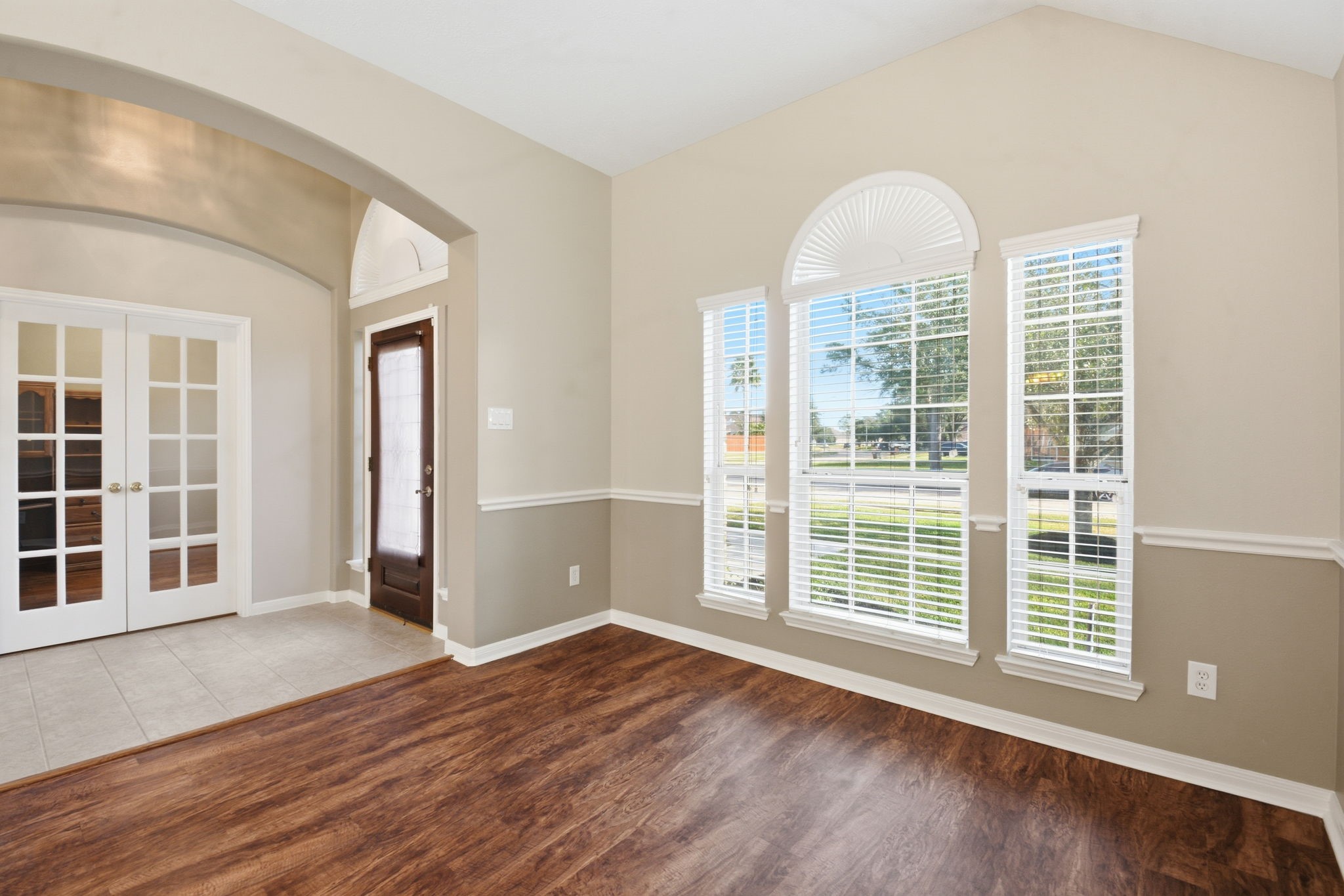 18915 Rustling Ridge Drive Tomball, TX 77377 - Photo 5 of 27 an empty room with wooden floor and windows