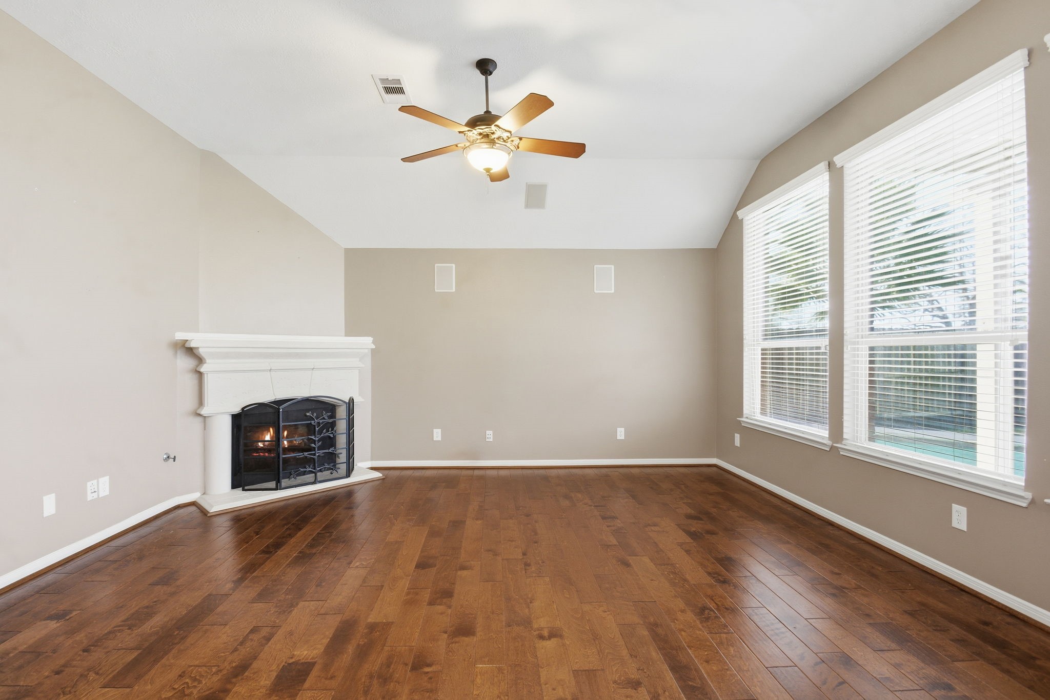 18915 Rustling Ridge Drive Tomball, TX 77377 - Photo 8 of 27 wooden floor fireplace and windows in an empty room