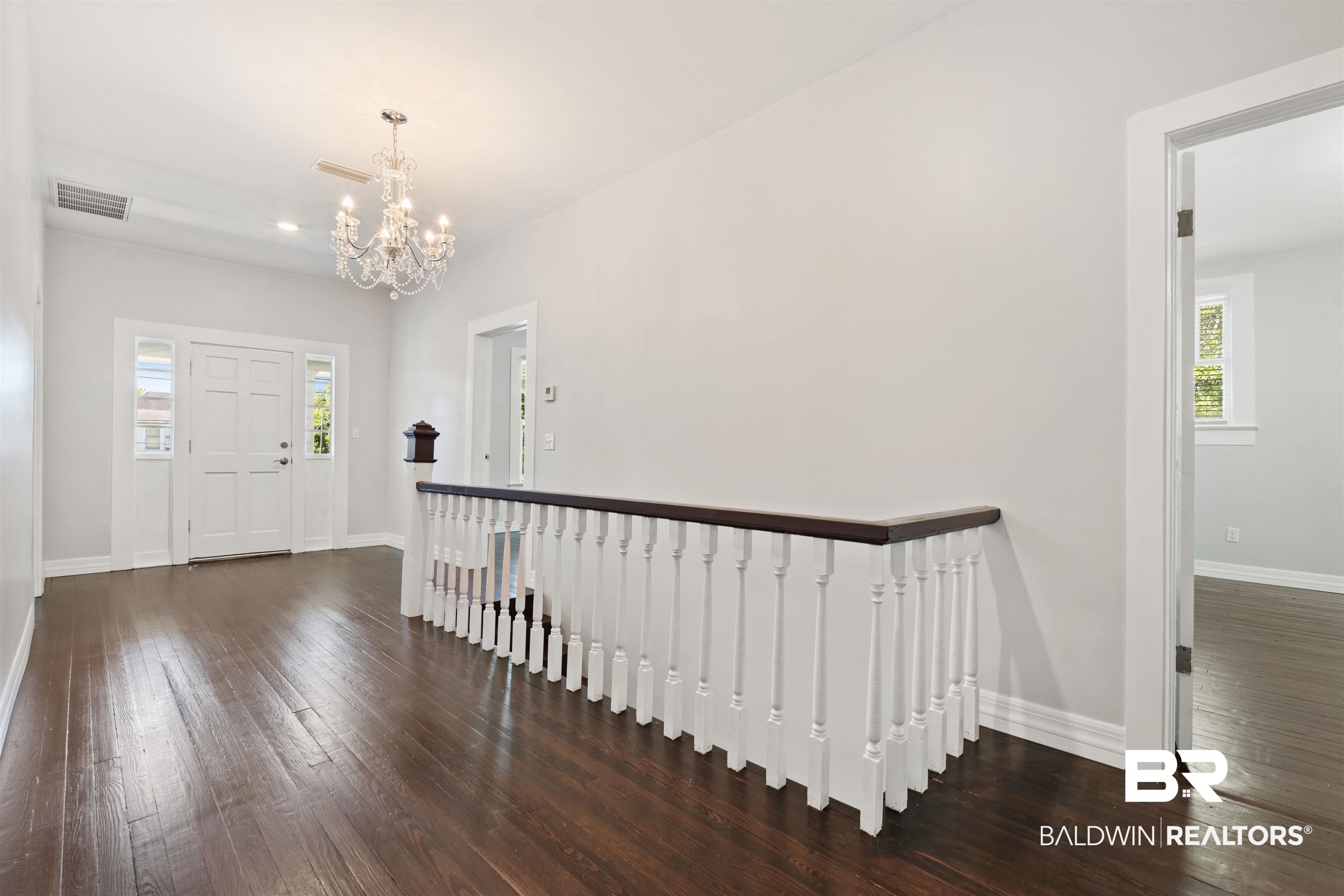 407 East 2nd Street Bay Minette, AL 36507 - Photo 27 of 40 Foyer featuring dark wood-style floors and a chandelier