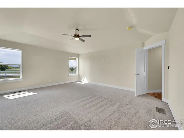 a bedroom with a large bed and a flat screen tv