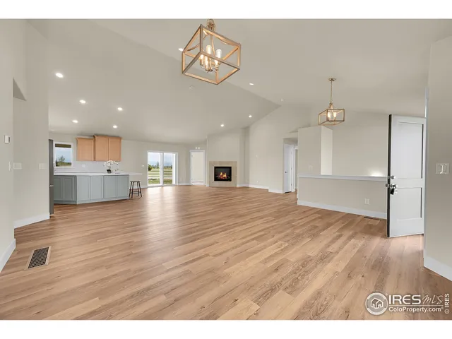 a living room with stainless steel appliances kitchen island granite countertop furniture and a view of kitchen