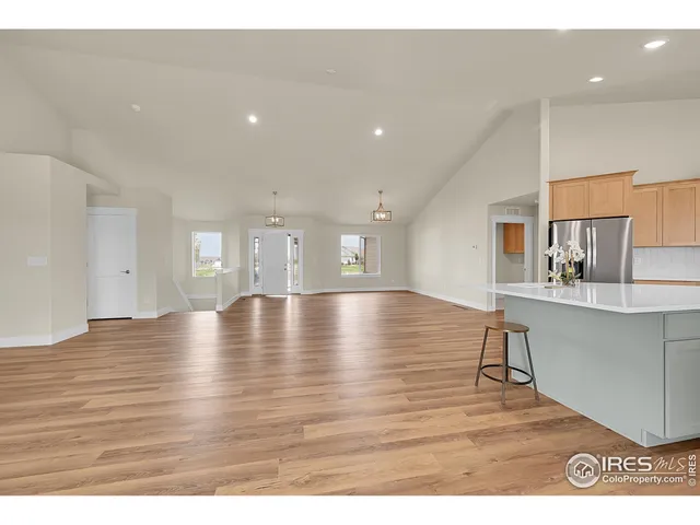 a living room with furniture a wooden floor and a sink