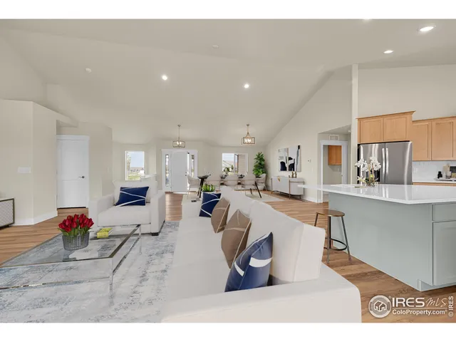 a open kitchen with stainless steel appliances granite countertop a large counter top a sink and a refrigerator