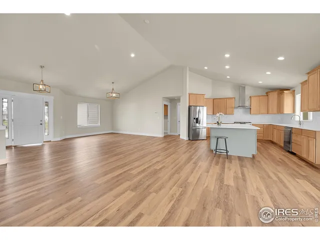 a living room with furniture and kitchen view