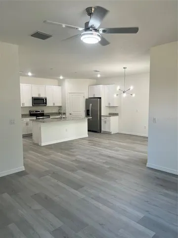 a view of a kitchen with a stove cabinets and wooden floor