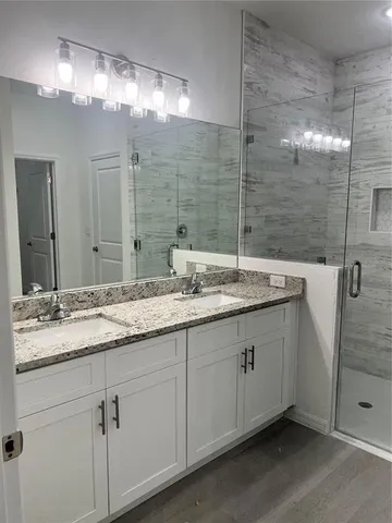 a bathroom with a double vanity sink and a mirror