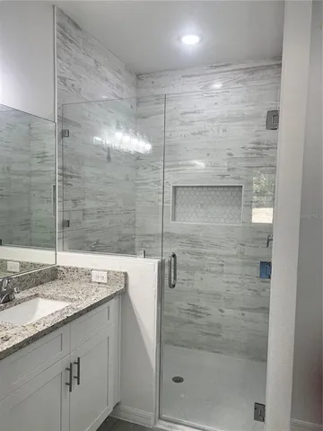 a bathroom with a shower and a sink