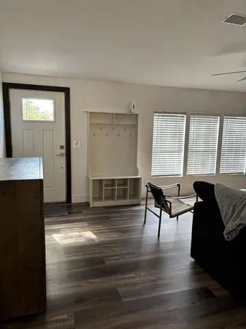 a kitchen with stainless steel appliances kitchen island granite countertop a stove a sink a dining table and chairs