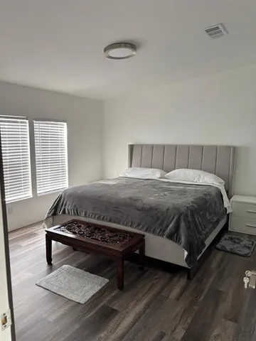a bedroom with a bed and a dresser