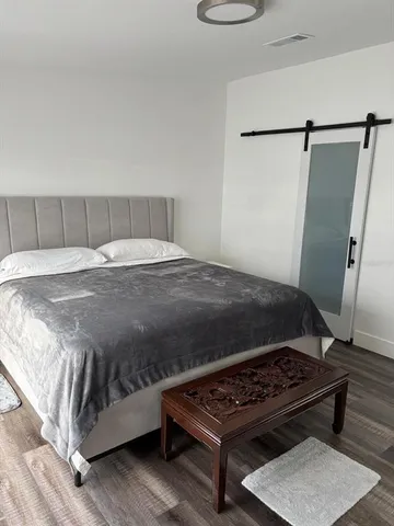 a bathroom with a granite countertop toilet sink and mirror