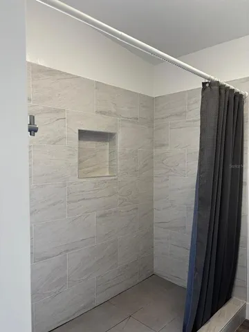 a bathroom with a shower and a window