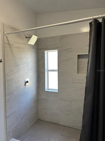 a bed sitting in a bedroom next to a window