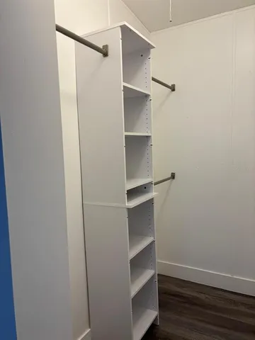a white toilet sitting next to a bathroom sink and vanity