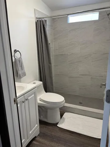 a bathroom with a sink toilet and mirror