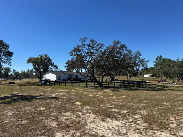 a backyard of a house with lots of green space