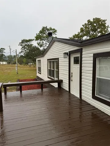 a view of a terrace with wooden floor and lake view