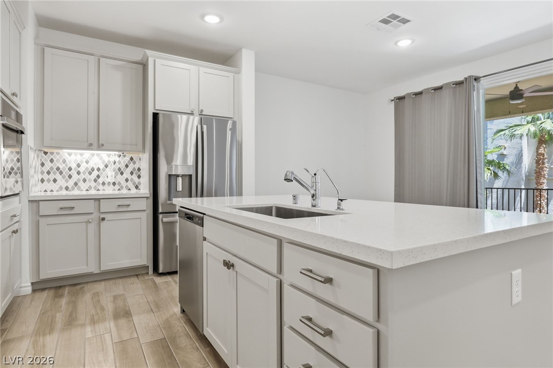 2555 Hampton Road, Unit 2208 Henderson, NV 89052 - Photo 11 of 45 Kitchen with s/s appliances, quartz counters and island, backsplash.