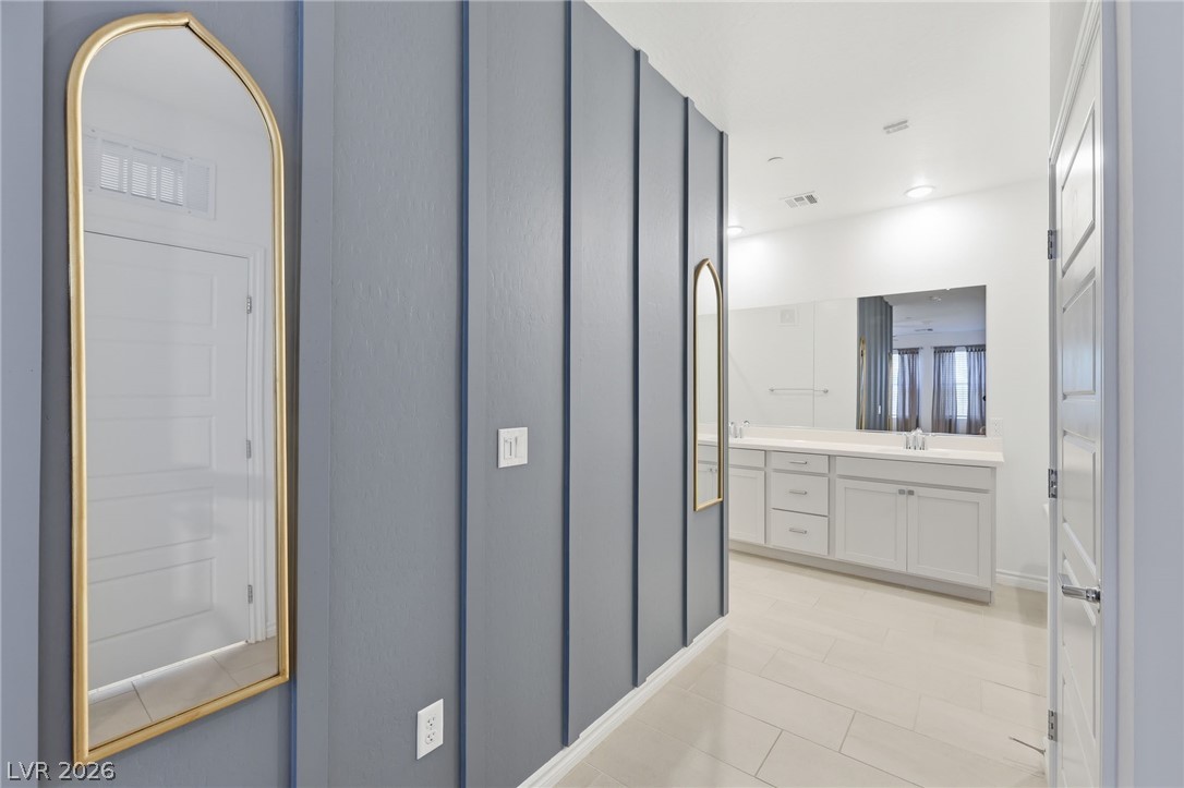 2555 Hampton Road, Unit 2208 Henderson, NV 89052 - Photo 17 of 45 Primary Bedroom - showing shiplap wall leading to the primary bathroom.
