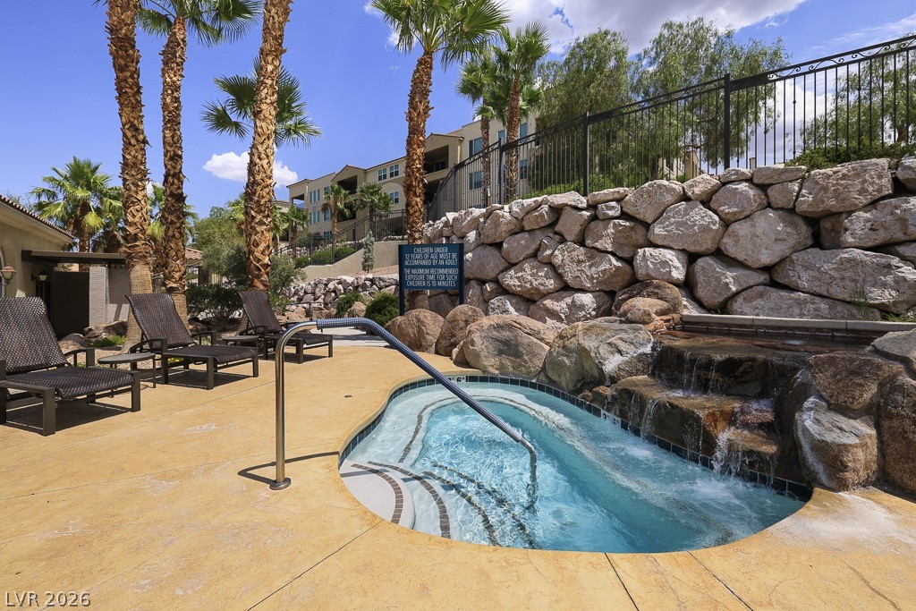 2555 Hampton Road, Unit 2208 Henderson, NV 89052 - Photo 33 of 45 Community Resort Pool and Spa. Enjoy tranquil moments, complete with a rock waterfall and lush palm trees.