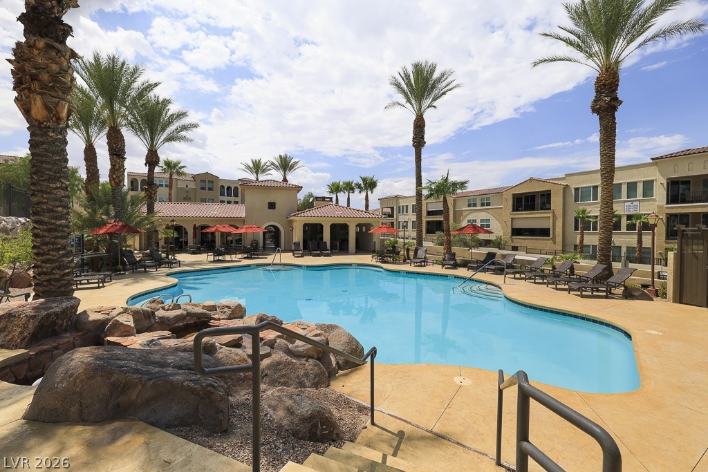 2555 Hampton Road, Unit 2208 Henderson, NV 89052 - Photo 34 of 45 Community Resort Pool and Spa. Enjoy tranquil moments, complete with a rock waterfall and lush palm trees.