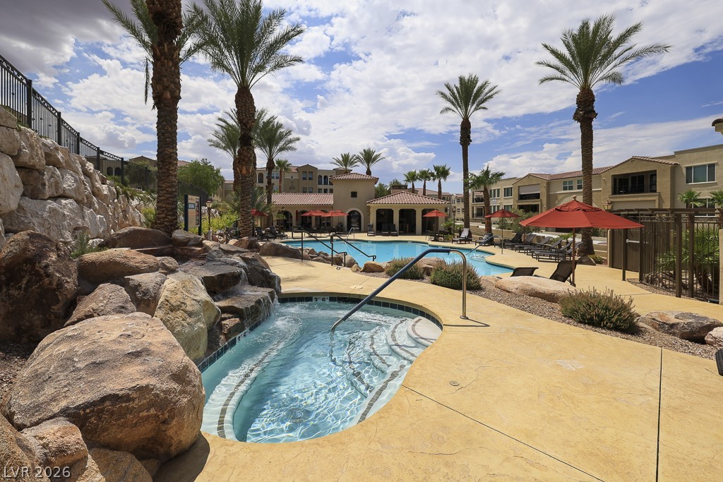 2555 Hampton Road, Unit 2208 Henderson, NV 89052 - Photo 35 of 45 Community Resort Pool and Spa. Enjoy tranquil moments, complete with a rock waterfall and lush palm trees.