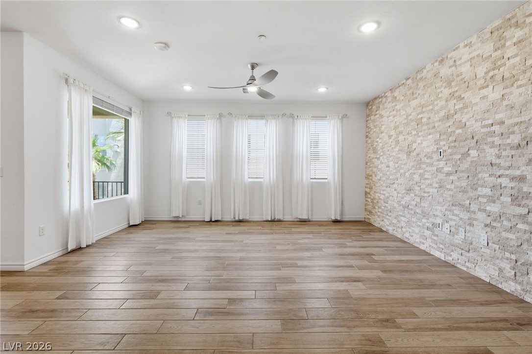 2555 Hampton Road, Unit 2208 Henderson, NV 89052 - Photo 6 of 45 Great Room features wood-look tile flooring and an elegant stone accent wall.