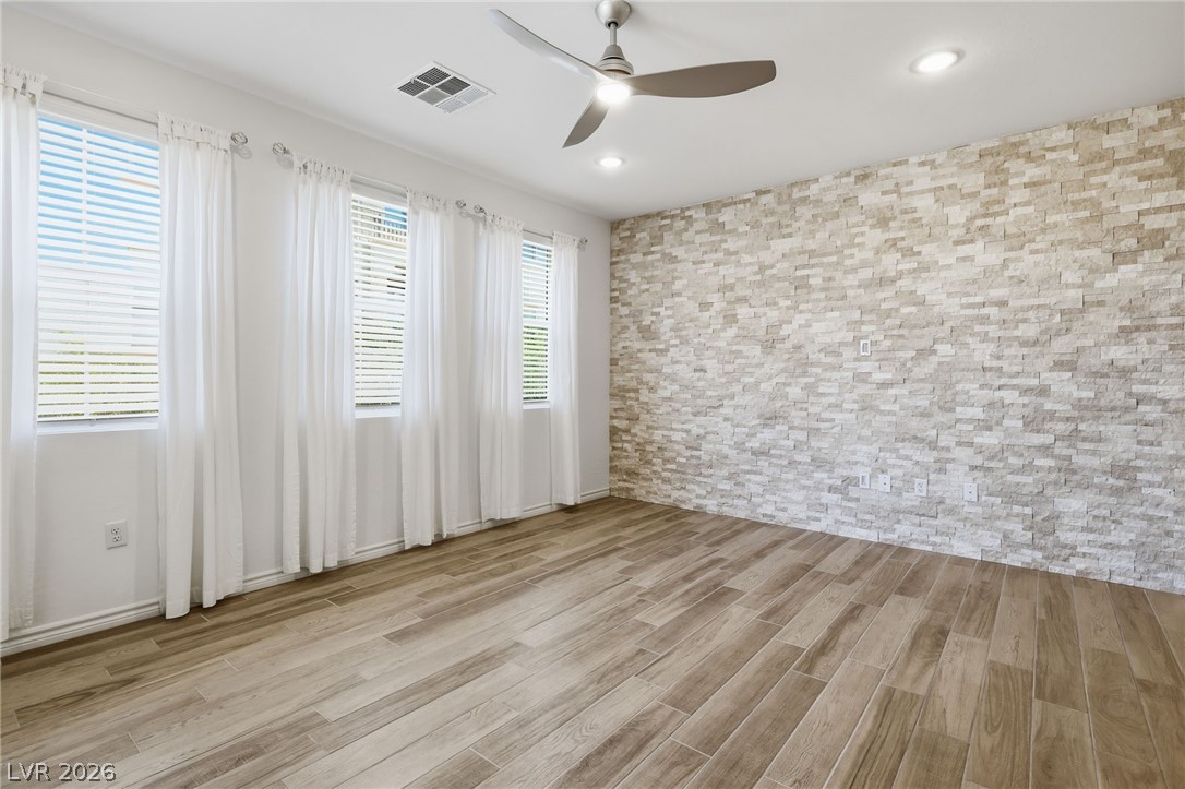 2555 Hampton Road, Unit 2208 Henderson, NV 89052 - Photo 7 of 45 Great Room features wood-look tile flooring and an elegant stone accent wall.