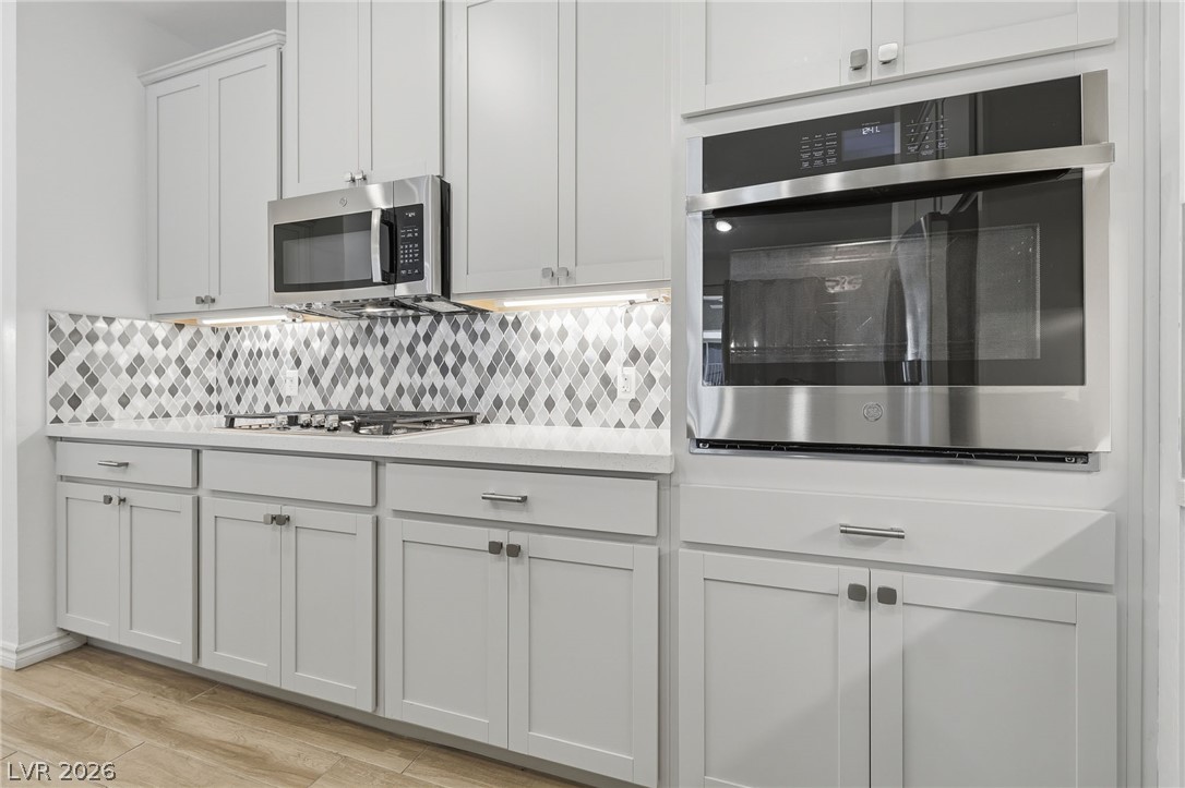 2555 Hampton Road, Unit 2208 Henderson, NV 89052 - Photo 10 of 45 Kitchen with s/s appliances, quartz counters and island, backsplash.