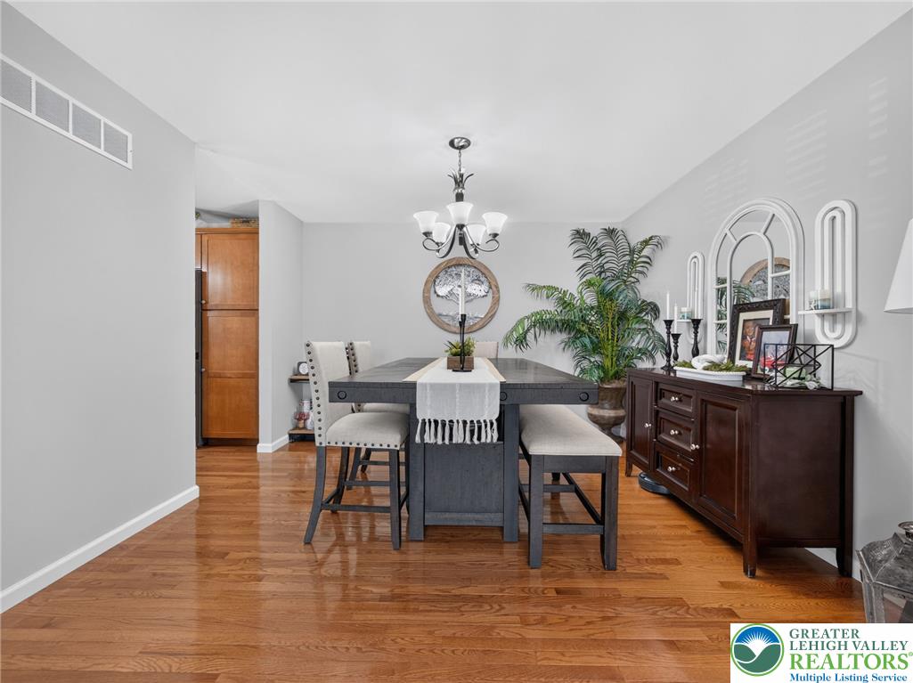 4148 Ross Road Bethlehem, PA 18020 - Photo 47 of 67 Hardwood floors complement this dining area, complete with an elegant chandelier and rich wood cabinetry.