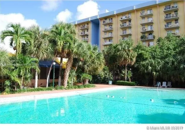 a view of a building with a yard