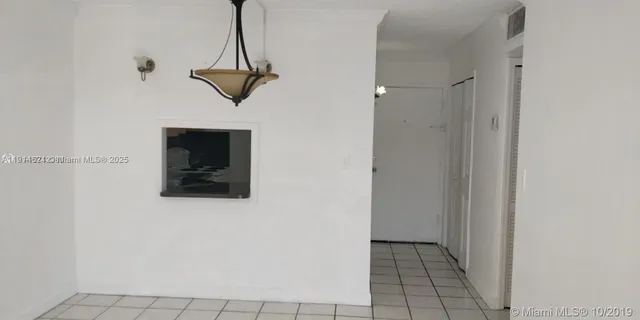 a view of a hallway with wooden floor and a table
