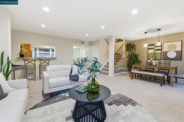 a living room with furniture and a potted plant