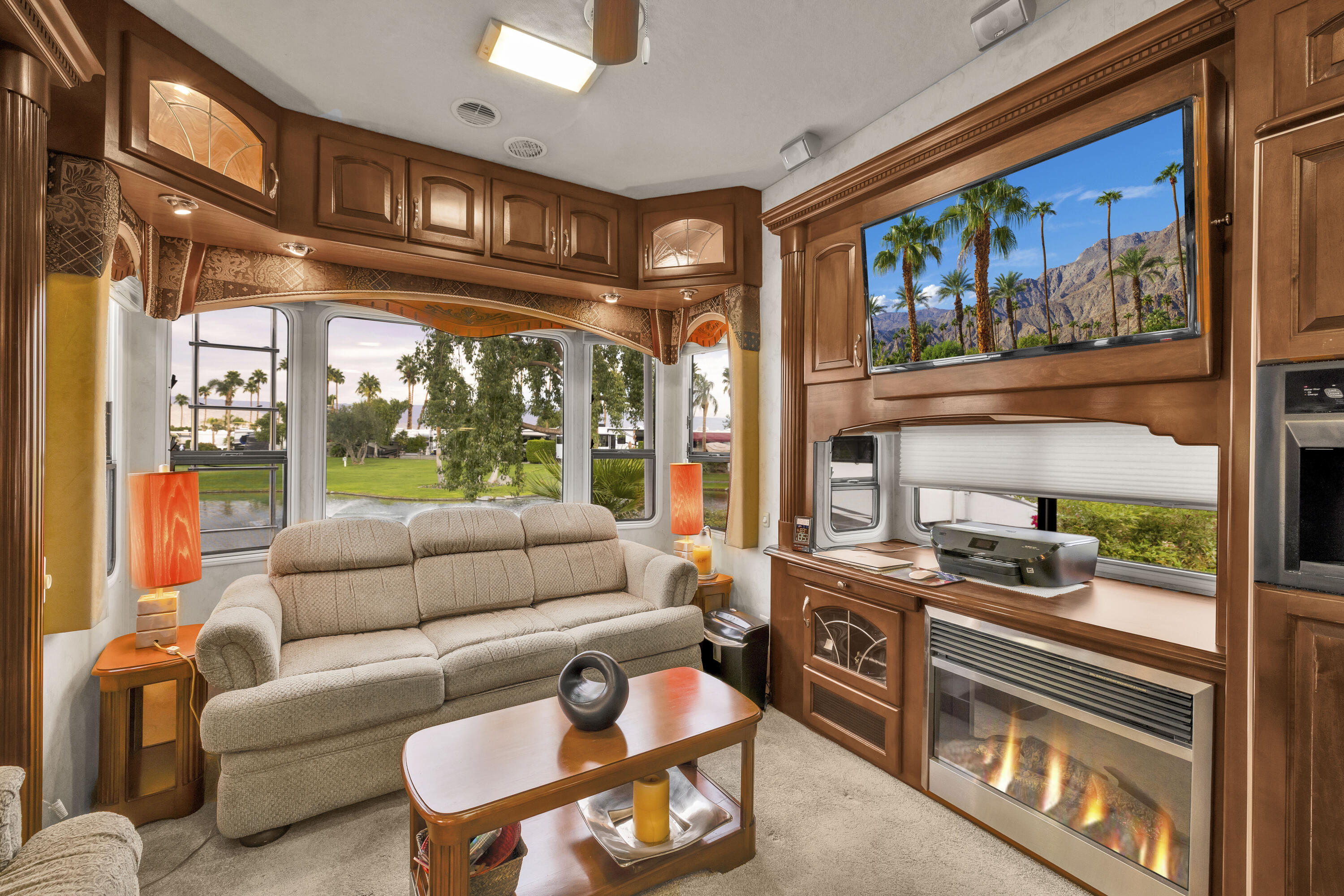 69411 Ramon Road, Unit 1203 Cathedral City, CA 92234 - Photo 13 of 74 a dining room with furniture a flat screen tv and a floor to ceiling window