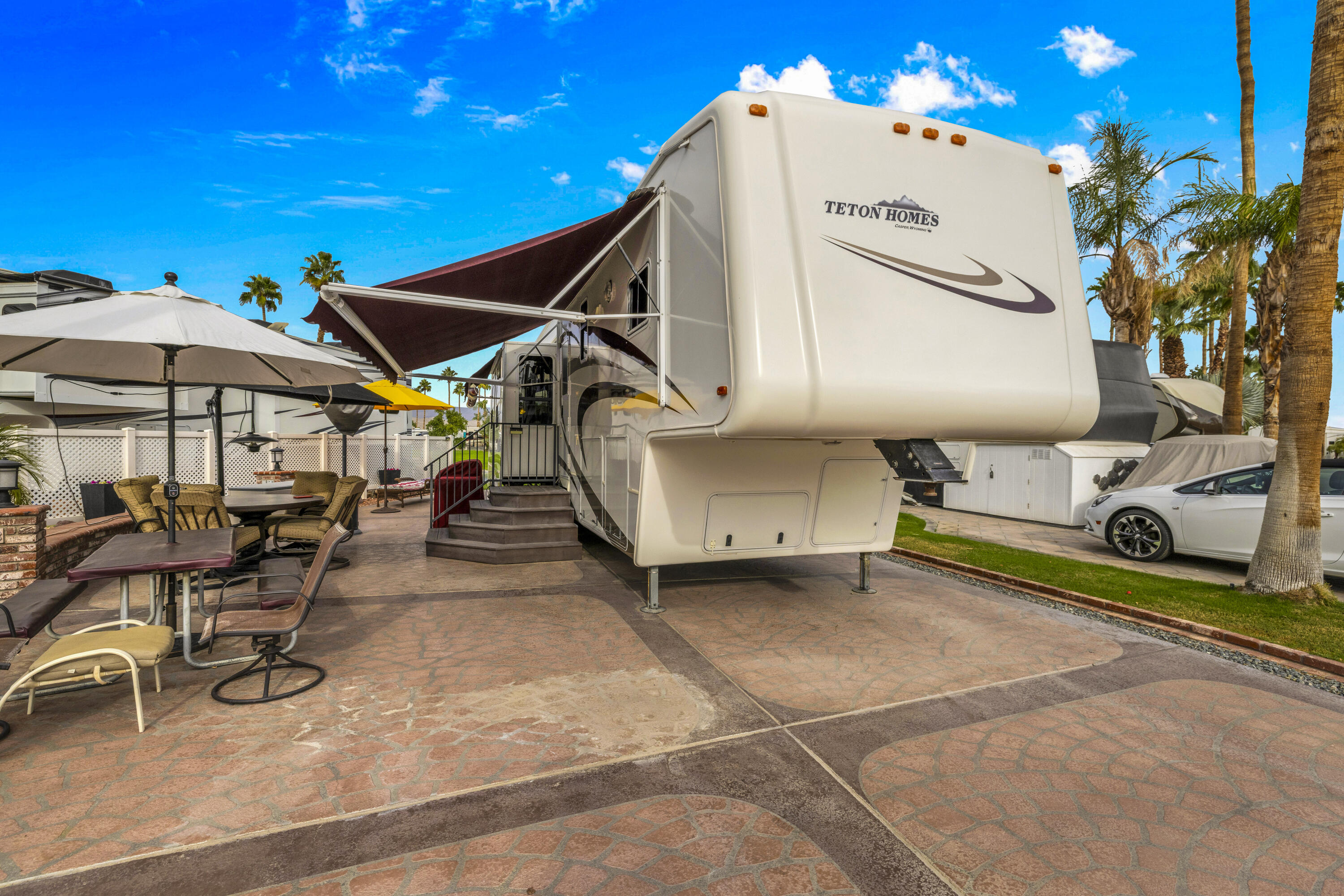 69411 Ramon Road, Unit 1203 Cathedral City, CA 92234 - Photo 22 of 74 a view of a patio with a table and chairs under an umbrella