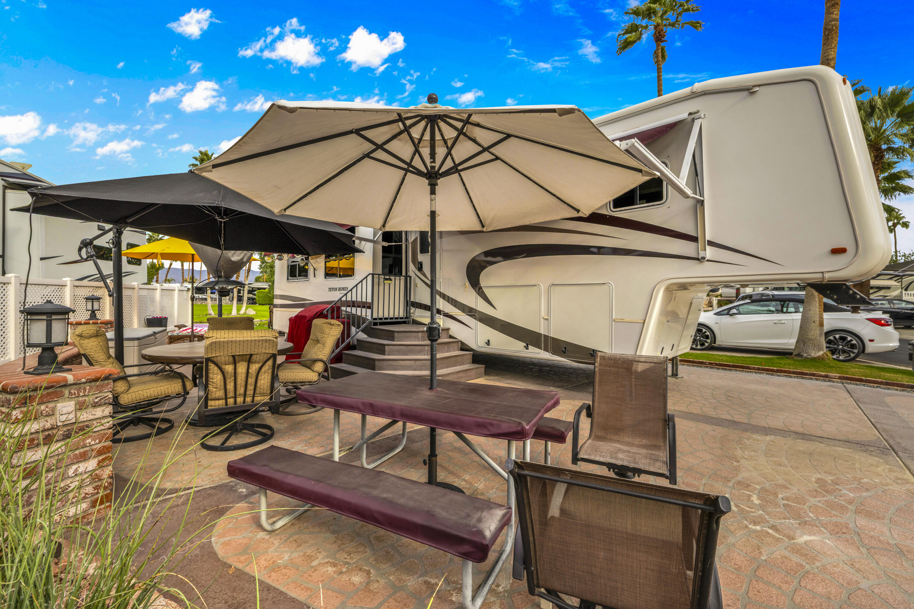 69411 Ramon Road, Unit 1203 Cathedral City, CA 92234 - Photo 23 of 74 a view of a patio with table and chairs under an umbrella
