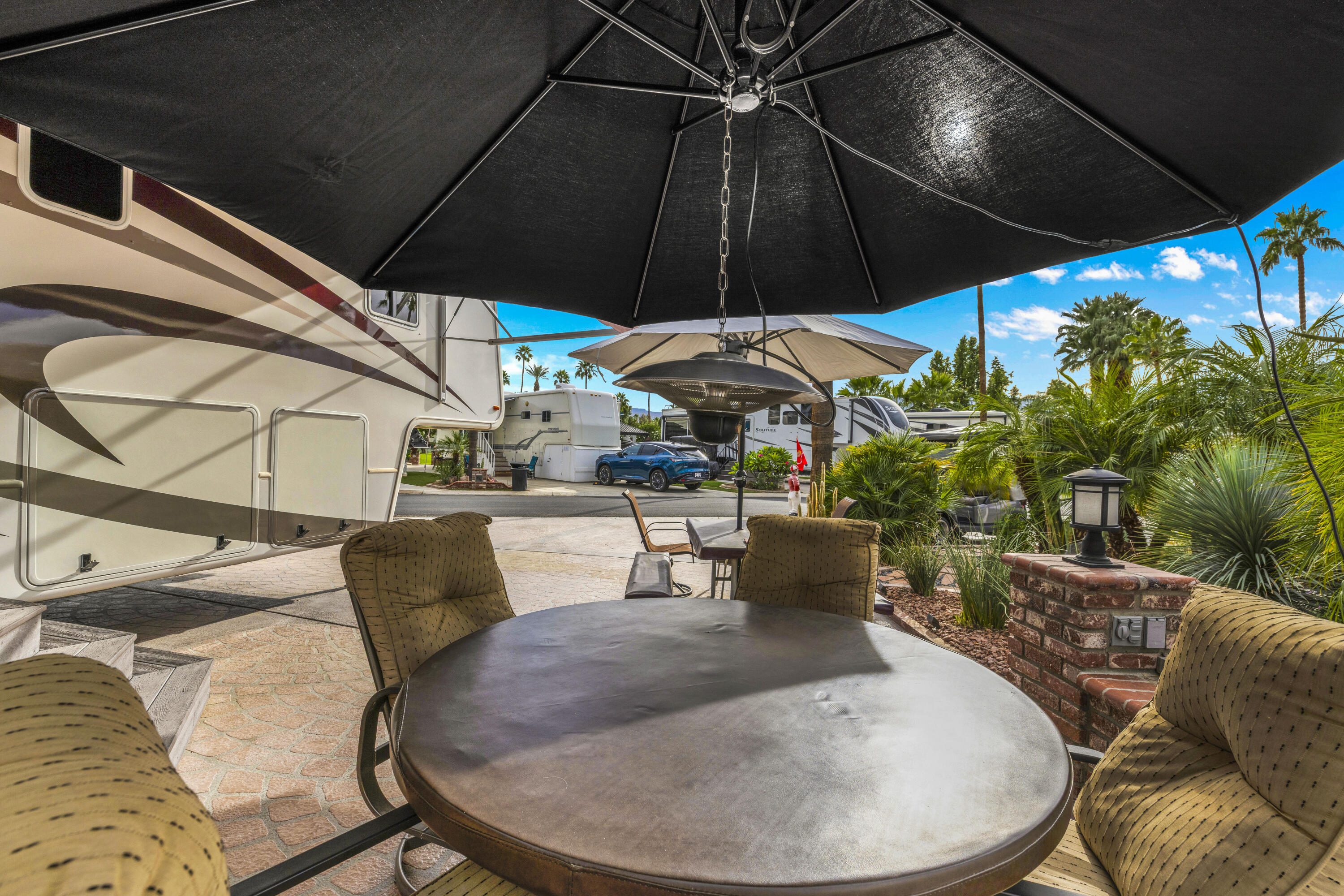 69411 Ramon Road, Unit 1203 Cathedral City, CA 92234 - Photo 27 of 74 a outdoor space with patio the couches and a umbrella