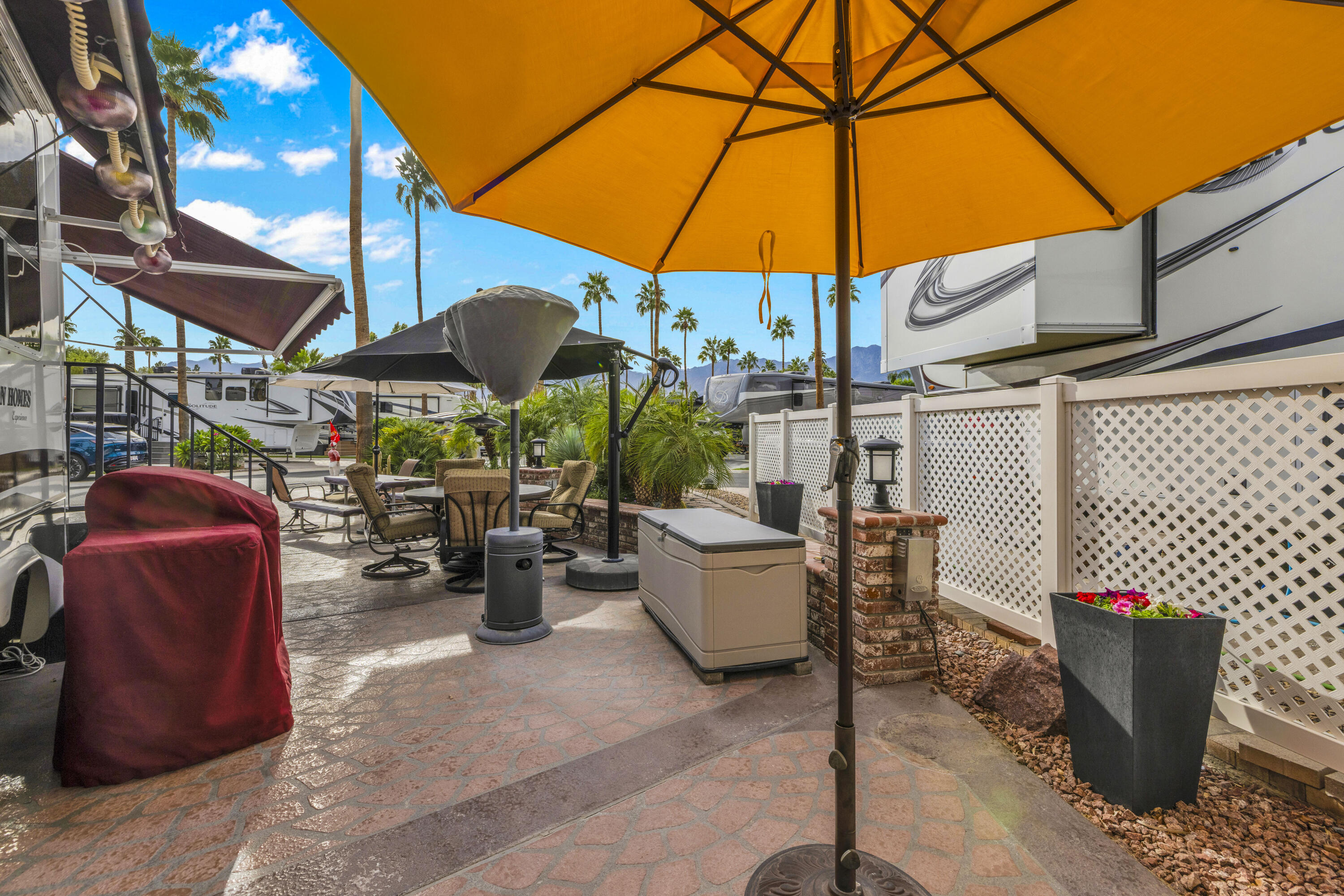 69411 Ramon Road, Unit 1203 Cathedral City, CA 92234 - Photo 28 of 74 a view of a patio with couches and table under an umbrella