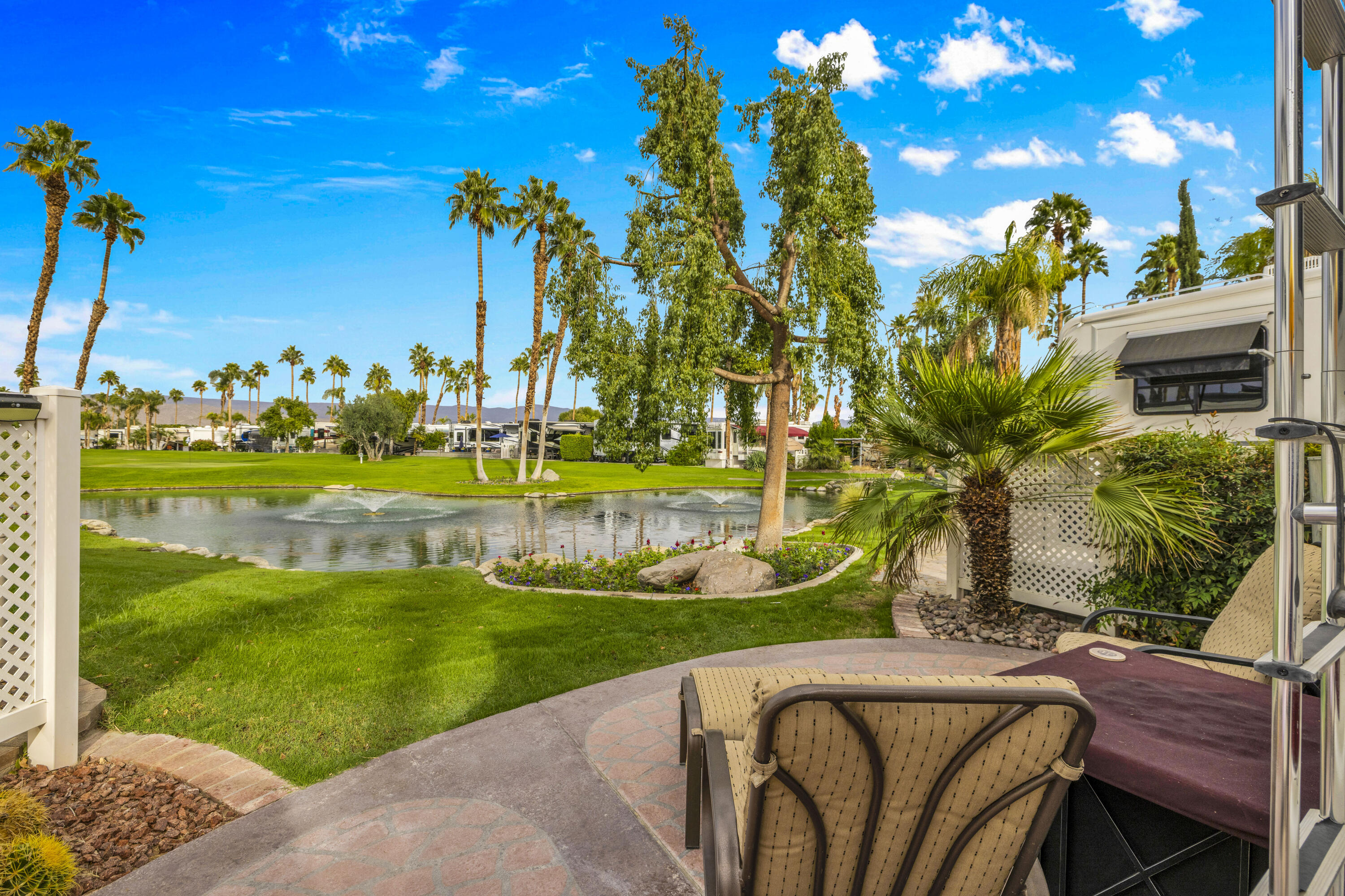 69411 Ramon Road, Unit 1203 Cathedral City, CA 92234 - Photo 5 of 74 a view of a swimming pool with a garden and plants