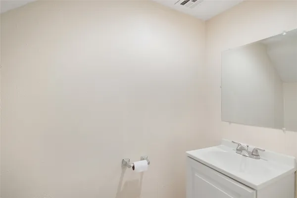 a bathroom with a sink and vanity